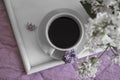 Cup of coffee, lilac flower in the apartment romantic floral