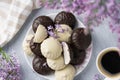 Cup of coffee, lilac, marshmallow in dark and white chocolate glaze. Sweet dessert in morning