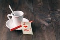Cup of coffee with lipstick mark and note 'i love you' on table Royalty Free Stock Photo