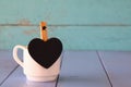 Cup of coffee and little heart shape chalkboard