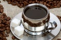 Cup of coffee with lump sugar and beans Royalty Free Stock Photo