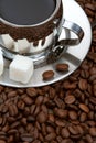 Cup of coffee with lump sugar and beans Royalty Free Stock Photo