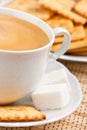 A cup of coffee with a lump sugar and crackers Royalty Free Stock Photo