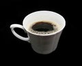 A Cup of coffee made of white ceramic with a film isolated on a black background Royalty Free Stock Photo