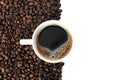 Cup of coffee with many coffee beans isolated on white background, top view Royalty Free Stock Photo