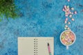 Cup with coffee and marshmallows, blank open notebook with pen on abstract blue background. Top view. Flat mockup. space for text Royalty Free Stock Photo