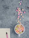 Cup with coffee and marshmallows, blank open notebook with pen on abstract blue background. Top view. Flat mockup. space for text Royalty Free Stock Photo