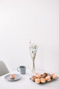 Cup of coffee with marshmallows and flowers on the table. Romantic morning. Tasty breakfast. Flat lay, top view, copy space. Royalty Free Stock Photo