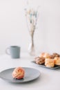 Cup of coffee with marshmallows and flowers on the table. Romantic morning. Tasty breakfast. Flat lay, top view, copy space.