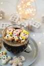 Cup of coffee with marshmallows. Marshmallow snowman in a Santa Claus hat. Winter drink. Christmas sweet food. Top view Royalty Free Stock Photo