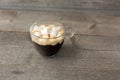 Cup of coffee with marshmallows on a wooden table. Street food Royalty Free Stock Photo