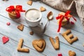 Cup of coffee and a message from a sweet cookie in the form of the word love. Romantic Valentine`s day gift Royalty Free Stock Photo