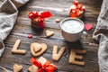 Cup of coffee and a message from a sweet cookie in the form of the word love. Romantic Valentine`s day gift Royalty Free Stock Photo