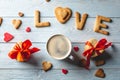 Cup of coffee and a message from a sweet cookie in the form of the word love. Romantic Valentine`s day gift Royalty Free Stock Photo