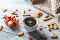 Cup of coffee and a message from a sweet cookie in the form of the word love. Romantic Valentine`s day gift Royalty Free Stock Photo