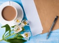 Cup of coffee with milk, blank paper in the envelope, pen and al Royalty Free Stock Photo