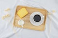 A cup of coffee, milk and butter cake on wooden plate Royalty Free Stock Photo