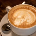 Cup of coffee with milk. Close up of Cappuccino with art on creamy foam. Rest break from business with natural energy Royalty Free Stock Photo