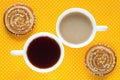 Cup of coffee with milk. A cup of tea. Two round cookies