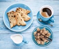 Cup of coffee, milk jug, cane sugar cubes and fruit-cake. Royalty Free Stock Photo