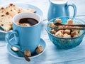 Cup of coffee, milk jug, cane sugar cubes and fruit-cake. Royalty Free Stock Photo