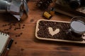 Cup of coffee, moka pot and  roasted coffee beans on wooden desk. Royalty Free Stock Photo