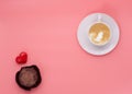 A cup of coffee muffin heart on pink background