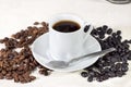 Cup of coffee beside natural roasted and torrefacto coffee beans Royalty Free Stock Photo