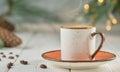 Cup of coffee with natural steam on a white wooden table, selective focus. Christmas background with copy space. Hot coffee drink