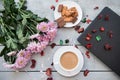 A Cup of coffee,note book , cracker, cookie, biscuit, lupins flowers on a wooden table. Royalty Free Stock Photo