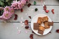 A Cup of coffee,note book , cracker, cookie, biscuit, lupins flowers on a wooden table. Royalty Free Stock Photo