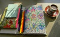 A cup of coffee, a notebook for creativity, pencils and a notebook on the table. Royalty Free Stock Photo