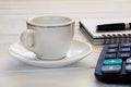 Cup of coffee, notebook with pen and calculator on white desktop Royalty Free Stock Photo