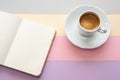 Cup of coffee and notebook with space for text on pastel color background