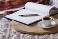 Cup with coffee, notepad, pen on the wooden desk on the bed. Royalty Free Stock Photo