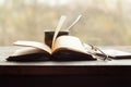 Cup of coffee, old book glasses and phone on the windowsill Royalty Free Stock Photo