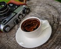 Cup of coffee and an old film camera Royalty Free Stock Photo