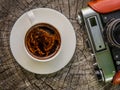 Cup of coffee and an old film camera Royalty Free Stock Photo