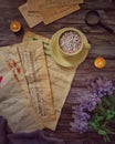 A cup of coffee, old music paper, old postcards, candles, magnifying glass and flowers Royalty Free Stock Photo