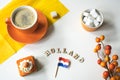 Cup of coffee, orange cake and eclair. Traditional treat for Dutch event Kings Day, Koningsdag Royalty Free Stock Photo