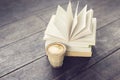 Cup of coffee and pack of books on vintage style floor