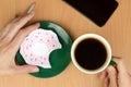 cup of coffee and a painted donut on a saucer. The concept of lack of food or money