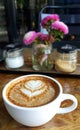 Cup of coffee with painted heart tree on foam