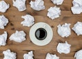 Cup of coffee paper sheets and crumpled wads on