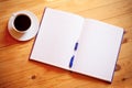 Cup of coffee, pen, opened organizer Royalty Free Stock Photo