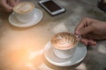 Cup coffee and phone on the table in coffee shop at morning