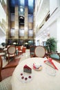 Cup of coffee and piece of cake on table in hall on big hotel