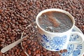 Cup of coffee and pile of coffee beans Royalty Free Stock Photo