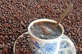 Cup of coffee and pile of coffee beans Royalty Free Stock Photo