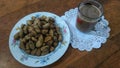 a cup of coffee and a plate of boiled peanuts